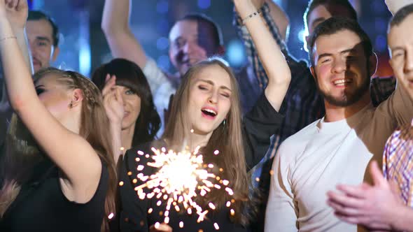 Friends are Holding Sparklers and Dancing Together