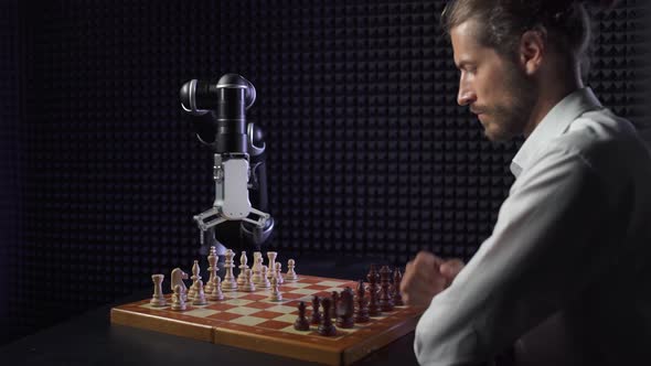 Robot Playing Chess with a Man, the Confrontation Between Man and Artificial Intelligence