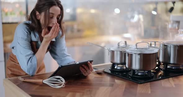 Woman with Digital Tablet While Cooking