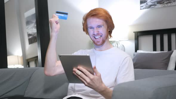 Successful Online Payment on Tablet by Casual Redhead Man