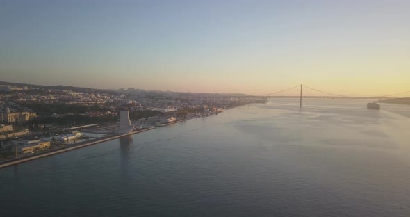 Discovery pattern with huge sunrise at the morning. Lisbon bridge and big travel ship on the frame.