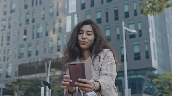 Portrait of Young Lady Making Selfie in Business District of Town