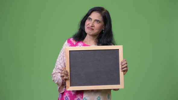 Mature Beautiful Indian Woman Showing Blackboard While Thinking