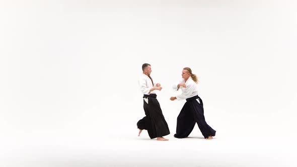 Two Men in Kimono Demonstrating Aikido Techniques, Isolated on White