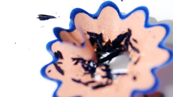 Blue color pencil shavings in a flower shape on a white background