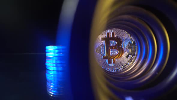 Gold Coin Bitcoin with Beautiful Blue and Yellow Light in the Ind of Tunnel, Glass Surface