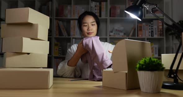 Woman pack a product to box