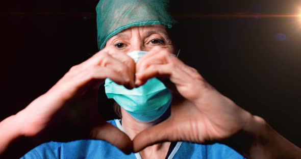 Female Doctor Makes the Heart Symbol with her Hands.