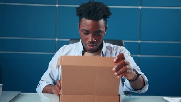 Frustrated African American Man Open Cardboard Box Receive Damaged Wrong Parcel