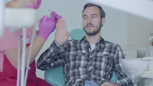 Skill Dentist in Medical Mask and Gloves Prepare To Checking the Tooths of the Patient Using Medical