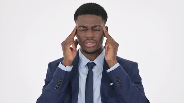 African Businessman Having Headache on White Background