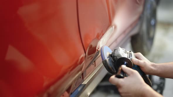 Garage Mechanic Removing Paint With the Angle Grinder Before Standing the Work