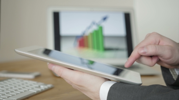  Fragment Of a Man In a Business Suit Working With The Tablet 