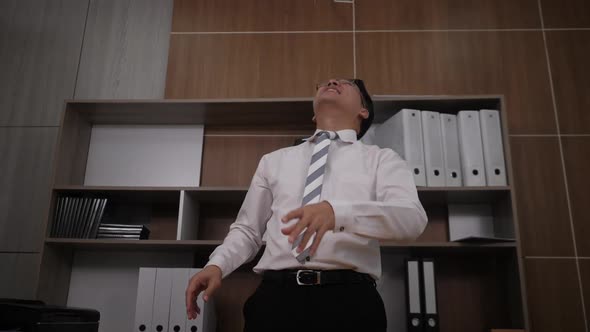 Businessman scatter the dollars and funny dancing in Office