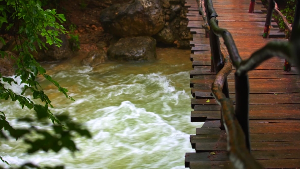 Wooden Bridge Hanging Over Rough River