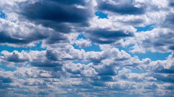 Timelapse of Layered Cumulus Clouds Moving in the Blue Sky