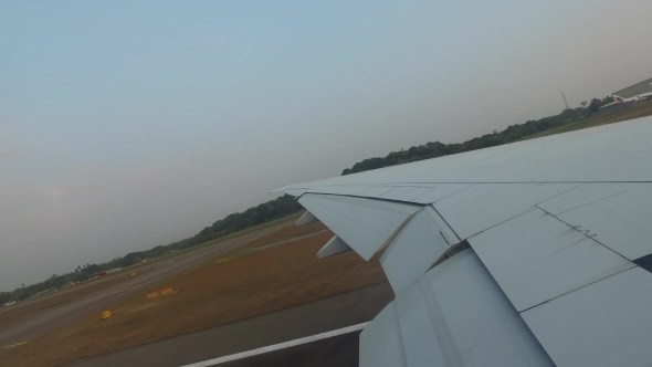 Wing Of Airplane Gathering Speed On Runway 100