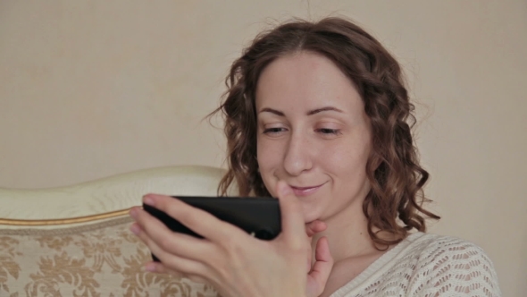 Woman Using Phone At Home