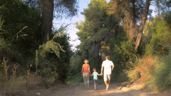 Child And Grandparents Running In The Forest