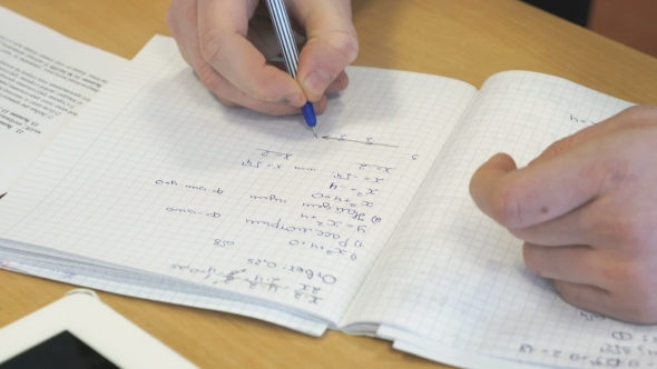 Girl Writes In a School Mathematics Notebook