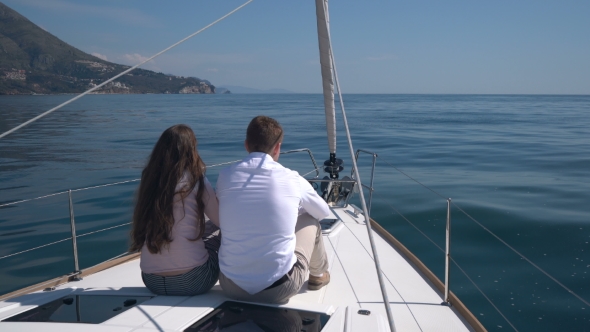 Enamored Couple Sitting On a Yacht