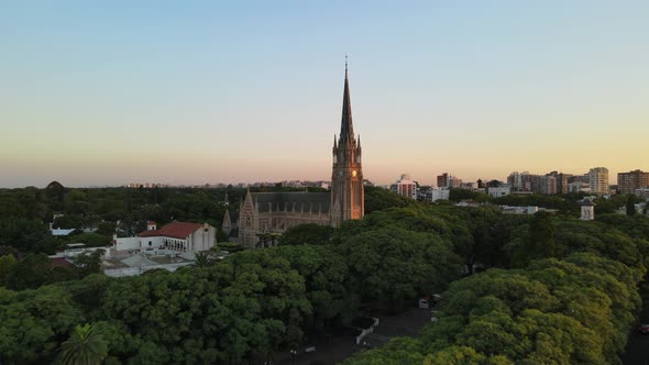 Aerial cinematic shot flying over San Isidro Cathedral at sunset