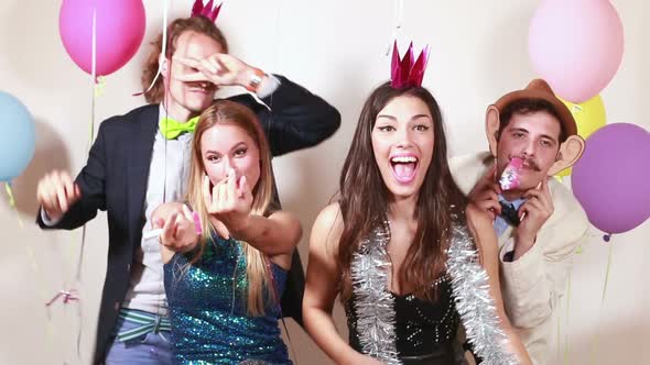 Group of funny crazy friends in photo booth
