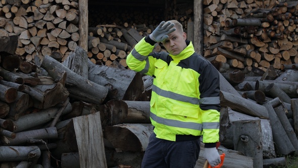 Exhausted From Work Lumberjack, Man Woodcutter. Sawn Logs, Firewood Background, Wood Harvesting