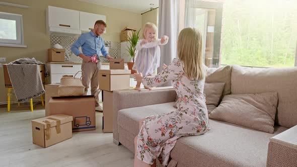 Active Family Group Move in Rent Real Estate. Positive Looking at Relocating or Unpacking of Carton