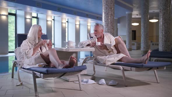 Aging Couple Enjoying Leisure in Hotel Near Pool