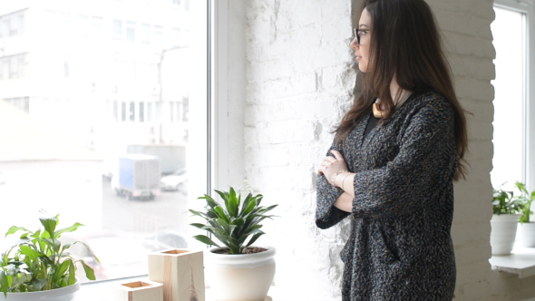 Standing Girl Looking Through Window and Thinking