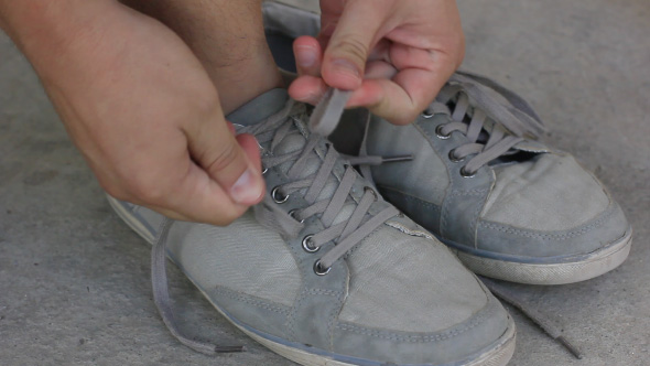 Man Tying The Shoelaces On His Running Shoes