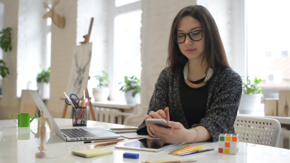 Female Designer Using Phone, Working in Office