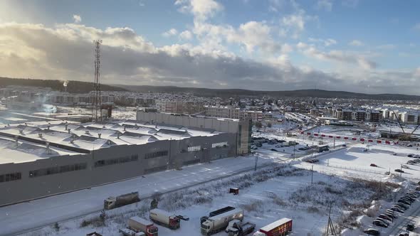 Snowfall on a Clear Winter or Spring Day in an Industrial Area