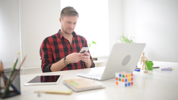 Creative Freelance Designer Working via Smartphone alt