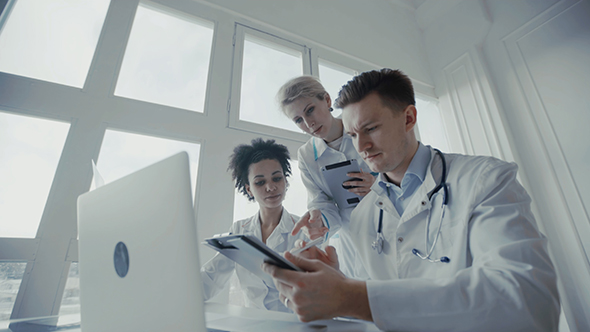 Group of Multi-Ethnic Doctors Discussing X-Ray Image