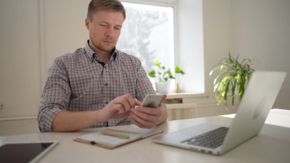 Freelancer Designer Busy Browsing on Smartphone alt
