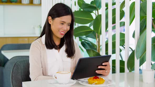 Asian Woman with Tablet Pc at Cafe or Coffee Shop