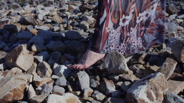  Detail Of a Woman's Feet In a Long Dress Standing On Big Stones