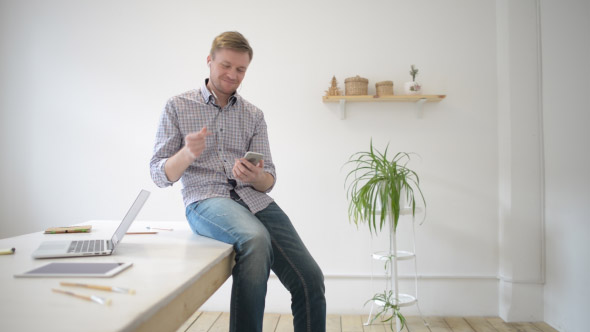 Relax Designer Listening Music in His Creative Office