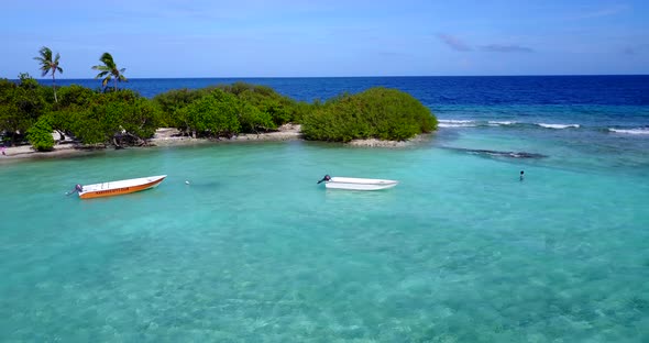 Wide angle aerial island view of a white paradise beach and aqua blue ocean background 