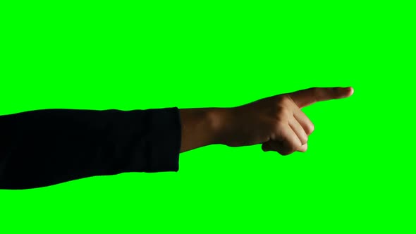 Person making hand gesture against green screen background