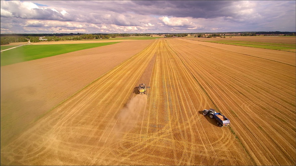 Closer Look of the Harvester and Truck on the Field