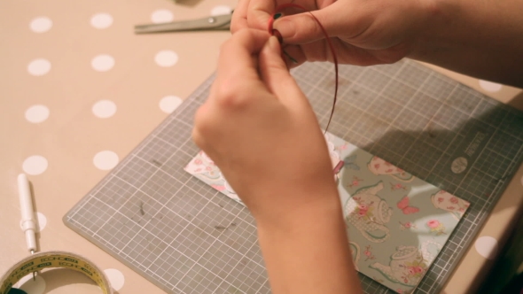 Hands Of a Woman Crafting And Scrap-booking Christmas Cards