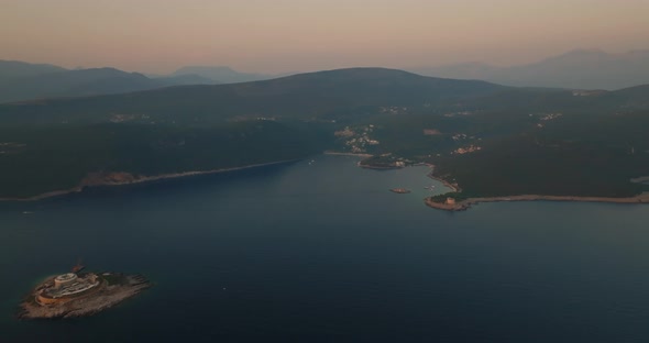 aerial view of mamula island , Otocic Gospa island and a bay during sunset