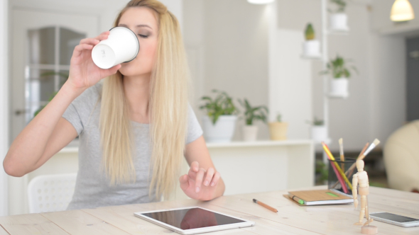 Drinking Coffee, Using Tablet at Work alt