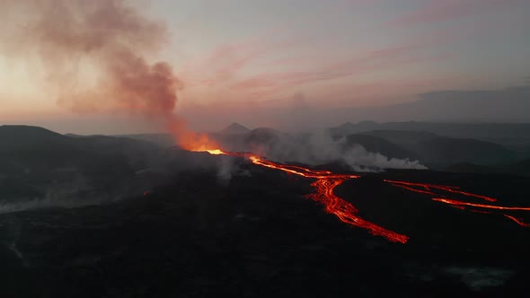 Crane Down Footage of Erupting Volcano Against Pink Dawn Sky