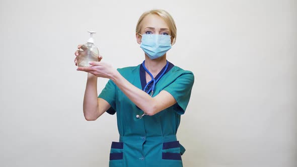 Medical Doctor Nurse Wearing Protective Mask - Holding Sanitizing Spray or Gel or Liquid Soap