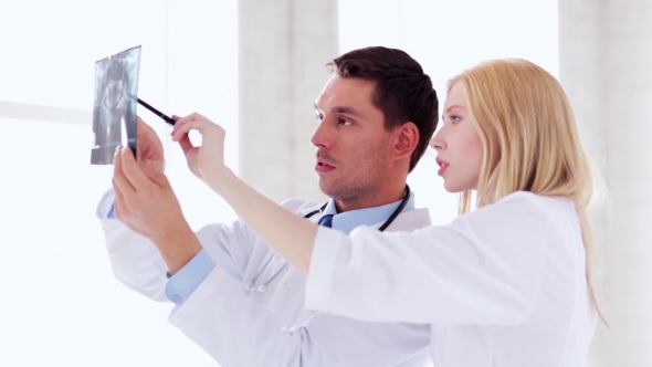 Two Doctors Discussing X-ray Image At Hospital 39