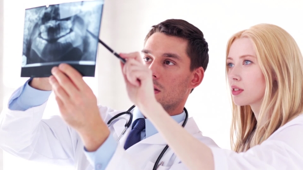 Two Doctors Discussing X-ray Image At Hospital 41